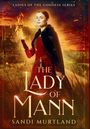 "THE LADY OF MANN" - Eine Frau in rotem Gewand hält magisch ein Feuer, im Hintergrund eine Burg bei Sonnenuntergang.