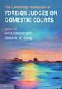 "The Cambridge Handbook of Foreign Judges on Domestic Courts." Wasser mit Farbreflexionen, im Hintergrund eine Küste.