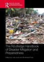 "The Routledge Handbook of Disaster Mitigation and Preparedness." Bearbeitet von Luke Juran und Bimal Kanti Paul. Trümmer und Palmen im Hintergrund.