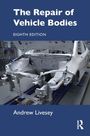 "The Repair of Vehicle Bodies, Eighth Edition, Andrew Livesey." Bild eines weißen Autowracks in einer Werkstattumgebung.