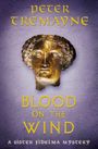 Text: "Peter Tremayne, Blood on the Wind, A Sister Fidelma Mystery". Bronze-Maske auf lila Hintergrund.