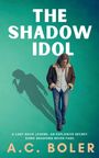 Oben steht "THE SHADOW IDOL". Darunter ein Mann, in Schatten ein Sänger mit Mikrofon. Text: "A LOST ROCK LEGEND..."