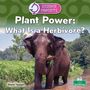 „Plant Power: What Is a Herbivore?“ Ein Elefant steht in einem Fluss, frisst Gras im Grünen unter blauem Himmel.