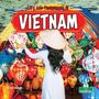 "Life and Traditions in VIETNAM". Eine Frau im weißen Kleid mit traditionellem Hut vor bunten Laternen.