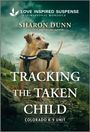 Texte über einem Hund: "LOVE INSPIRED SUSPENSE", "SHARON DUNN", "TRACKING THE TAKEN CHILD", "COLORADO K-9 UNIT". Hund mit "K-9 UNIT"-Weste vor Berglandschaft.