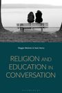 Text: "Maggie Webster & Seán Henry. RELIGION AND EDUCATION IN CONVERSATION." Zwei Personen sitzen auf einer Bank am Wasser.