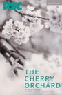 Text: "THE CHERRY ORCHARD, BY ANTON CHEKHOV, IN A NEW VERSION BY LAURA WADE." Schwarzweißes Foto von Kirschblüten.