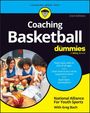 „Coaching Basketball for Dummies“ zeigt lächelnde Jugendliche im Kreis in Sportkleidung mit einem Basketball.