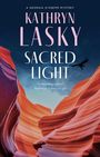 "KATHRYN LASKY SACRED LIGHT" ist ein Buchcover mit bunten, geschwungenen Felsen und einem fliegenden Vogel.