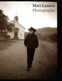 Text: "Matt Lankes Photographs". Ein Mann mit Hut geht auf einem Feldweg; im Hintergrund eine kleine Kirche.