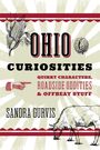 "Ohio Curiosities" Text mit Illustrationen von Maiskolben, stacheliger Frucht, Richtungspfeil und einer Kuh.