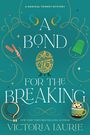 „A Magical Trinket Mystery: A Bond for the Breaking“ von Victoria Laurie. Illustrationen: Zauberstab, Ei, Fingerhut, Tasse.