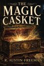 „The Magic Casket“; „R. Austin Freeman“. Eine Schatztruhe mit strahlendem Licht, verziert mit Gold und Edelsteinen.