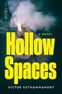 Text: "Hollow Spaces", "A Novel", "Victor Suthammanont". Hintergrund: Stadtansicht mit Matchflamme und Rauch.