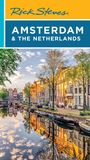 "Amsterdam & The Netherlands" über einem Kanal mit Booten und bunten Häusern, atmosphärisch bei Sonnenuntergang.