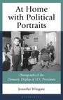"At Home with Political Portraits" von Jennifer Wingate. Ein Junge steht in einer Küche; im Hintergrund Personen und Bilder.