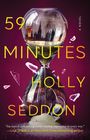 „59 Minutes Holly Seddon“. Eine Sanduhr spiegelt eine Stadtsilhouette, umgeben von Glassplittern.