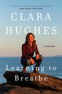 Text: "CLARA HUGHES", "Learning to Breathe: A Memoir", "Author of the #1 National Bestseller". Frau sitzt auf Felsen am Meer.