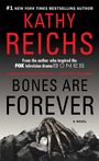 Text: KATHY REICHS, BONES ARE FOREVER, A NOVEL. Ein Skelettarm liegt auf Steinen, darunter ein heller Edelstein.