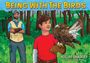 Titel: "BEING WITH THE BIRDS". Ein Junge mit Vogel auf dem Arm, ein Mann im Hintergrund im Wald, kräftige Farben.