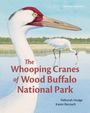 Text: "The Whooping Cranes of Wood Buffalo National Park." Illustration von Kranichen an einem Wasserlauf mit Bäumen im Hintergrund.