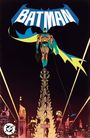 Der Text "BATMAN" in großen Buchstaben. Eine Illustration zeigt Batman auf einem hohen Gebäude in einer nächtlichen Stadtansicht.