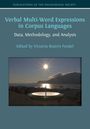 Verbal Multi-Word Expressions in Corpus Languages. Sonnenuntergang über Bergen, reflektiert in einem Sonnenkompass.