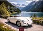 Porsche Classic Cars; Casares Edition 2027. Weißer Oldtimer vor Bergsee und Alpenlandschaft in sonniger Umgebung.