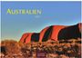 Text: "AUSTRALIEN 2027". Roter Felsen im Sonnenlicht, umgeben von niedriger Vegetation, blauer Himmel.