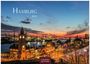 Hamburg 2027. Casares Edition. Abendhimmel über dem Hafen von Hamburg mit beleuchteter Architektur und Hafenkränen.