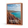 Text: "Australia 100 Legendary Places". Bild: Roter Felsen und türkisfarbenes Meer unter blauem Himmel.