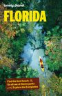 "FLORIDA" in großen gelben Buchstaben, darüber "lonely planet" und darunter Tipps zu Stränden, Themenparks, Everglades. Eine Luftansicht von üppigem, grünen Wald und einem gelben Kanu auf einem klaren Fluss.