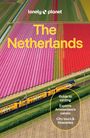 Oben: "lonely planet The Netherlands." Unten: Ein gelber Zug neben bunten Tulpenfeldern.