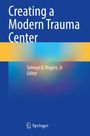 "Creating a Modern Trauma Center" von Selwyn O. Rogers, Jr., Editor. Unten ein Springer-Logo. Design mit Blau- und Gelbtönen.