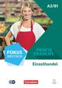 A2/B1, FOKUS DEUTSCH, PROFIS GESUCHT, Einzelhandel. Frau in roter Schürze vor verschwommenem Supermarkt-Hintergrund.