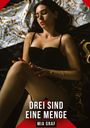 Texte: "Drei sind eine Menge", "Mia Graf". Frau in schwarzer Unterwäsche liegt auf einem dekorativen Bettlaken.