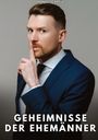 MANUEL GARCÍA, GEHEIMNISSE DER EHEMÄNNER. Ein Mann in Anzug mit ernstem Blick hält den Finger an die Lippen.