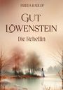 Frieda Radlof, Gut Löwenstein, Die Rebellin. Eine Frau in blauem Kleid steht an einem nebligen See vor Bäumen.
