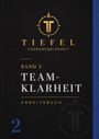 "TIEFEL FÜHRUNGSKLARHEIT, Band 2 TEAMKLARHEIT, ARBEITSBUCH" - Goldenes Logo mit T auf schwarzem Hintergrund.