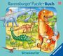 „Ravensburger Puzzle-Buch“, „Dinosaurier“. Illustration mit bunten Dinosauriern vor Vulkan und Bäumen.