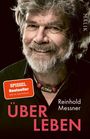 "Über Leben", Reinhold Messner, Spiegel Bestseller. Ein Mann mit Bart lächelt, trägt eine Halskette.