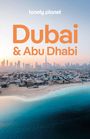 Text: "lonely planet", "Dubai & Abu Dhabi". Skyline, Strand und blaues Meer bei Sonnenuntergang.