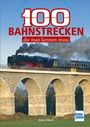 "100 Bahnstrecken, die man kennen muss". Ein Zug auf einem steinernen Viadukt, viel Rauch, blauer Himmel.