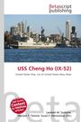"USS Cheng Ho (IX-52)", ein Text in Rot. Ein großes Schiff vor einer Stadt mit Hochhäusern im Hintergrund.