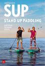 Text: "Christian Barth SUP Stand Up Paddling Material Technik Spots." Zwei Personen stehen auf Paddleboards auf dem Wasser.