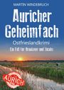 Text: "Auricher Geheimfach. Ostfrieslandkrimi. Ein Fall für Brookmer und Jacobs. Martin Windebruch." Landschhaft mit Kühen und Sonnenuntergang.