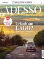 "Urlaub am Lago? Ja, aber in Umbrien!" zeigt ein Auto auf einer Straße zum See im Sonnenuntergang.