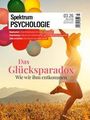 Spektrum Psychologie 03.26. "Das Glücksparadox: Wie wir ihm entkommen." Person mit Ballons in sonniger Landschaft.