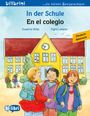 Oben steht "In der Schule / En el colegio". Darunter eine Illustration von drei Kindern vor einer gelben Schule.