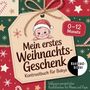 "Mein erstes Weihnachtsgeschenk" auf einem Geschenkanhänger mit Baby in Weihnachtsmütze, Geschenkpapier.